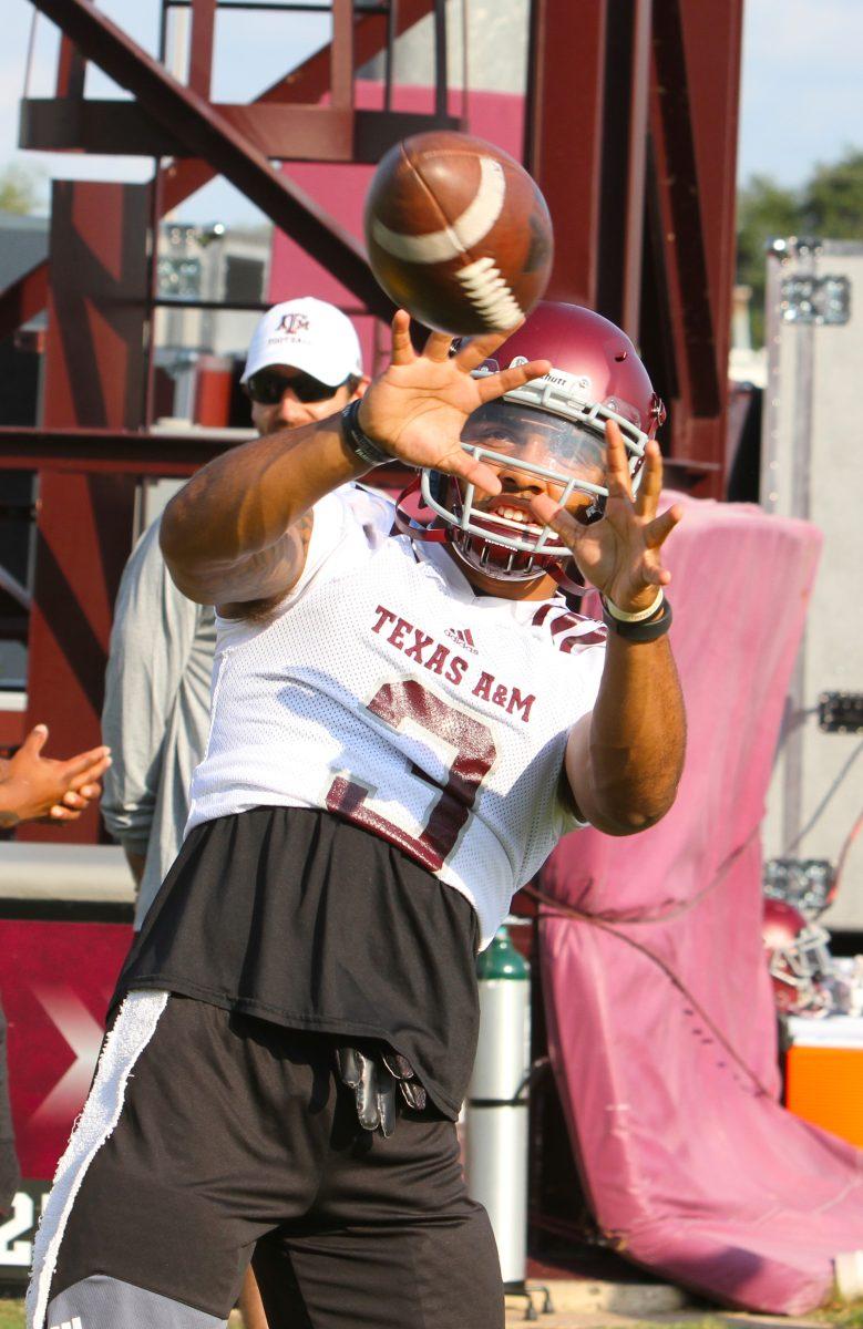 Junior wide receiver&#160;Christian Kirk&#160;plays catch with freshman wide receiver&#160;Hezekiah Jones on the sideline.