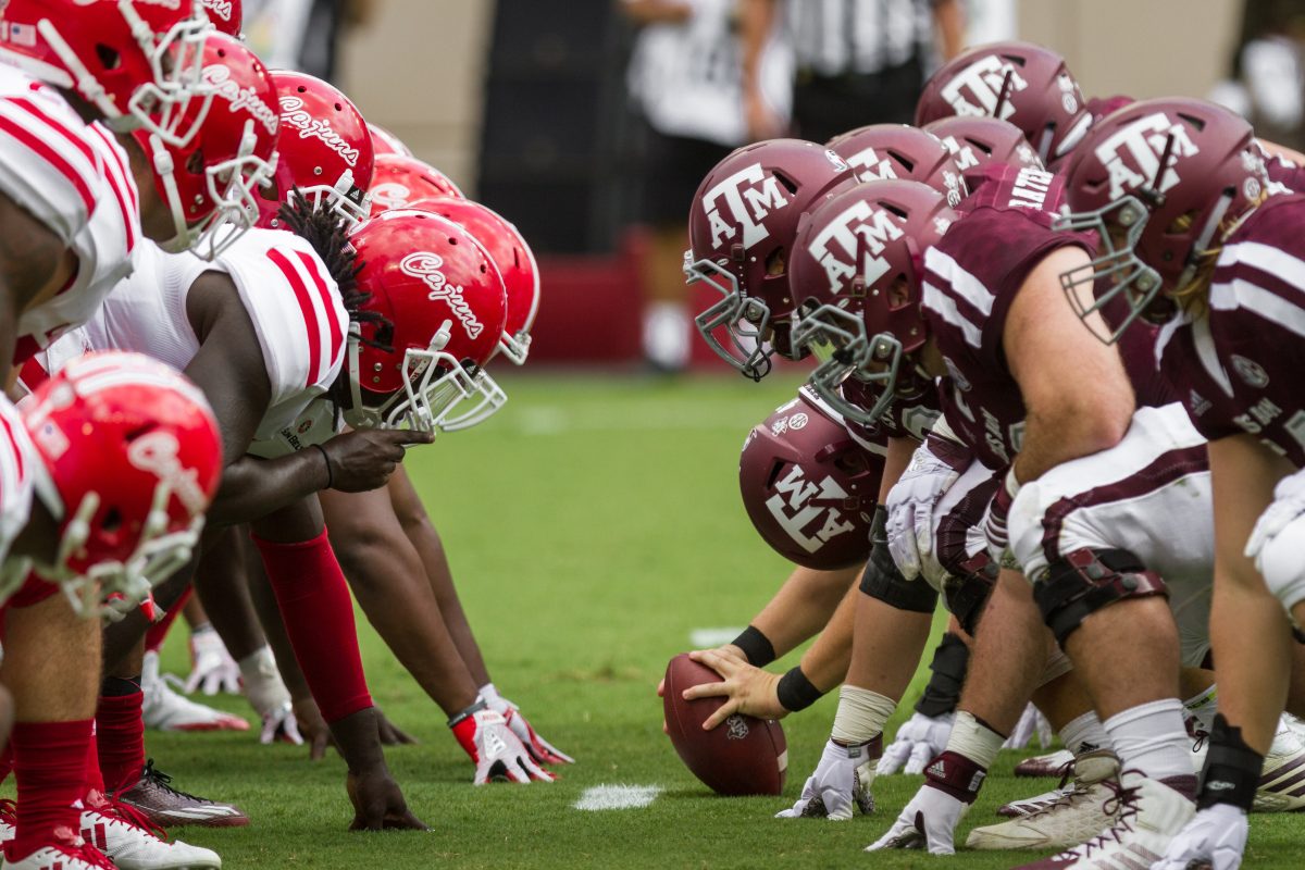 <p>The trench created between the Ragin Cajuns defensive front and Aggies offensive line prepares to disappear as the ball is snapped. </p>