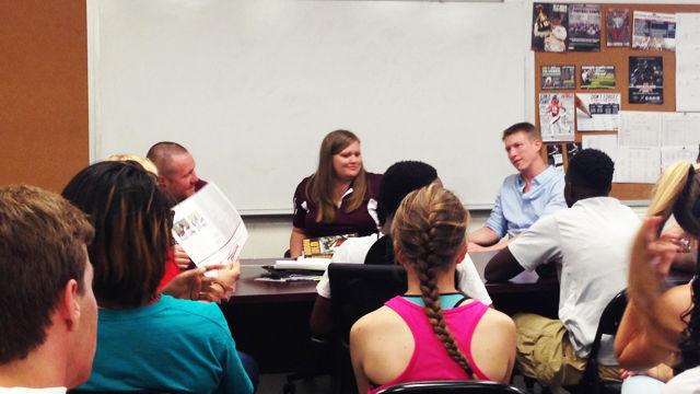 (Left to right) Dr. John Eric Smith and Dr. Megan Holmes from Mississippi State University and Dr. Neil Johannsen from Louisiana State University talk with high school athletes about the importance of nutrition and hydration during an SEC Faculty Travel Program visit.