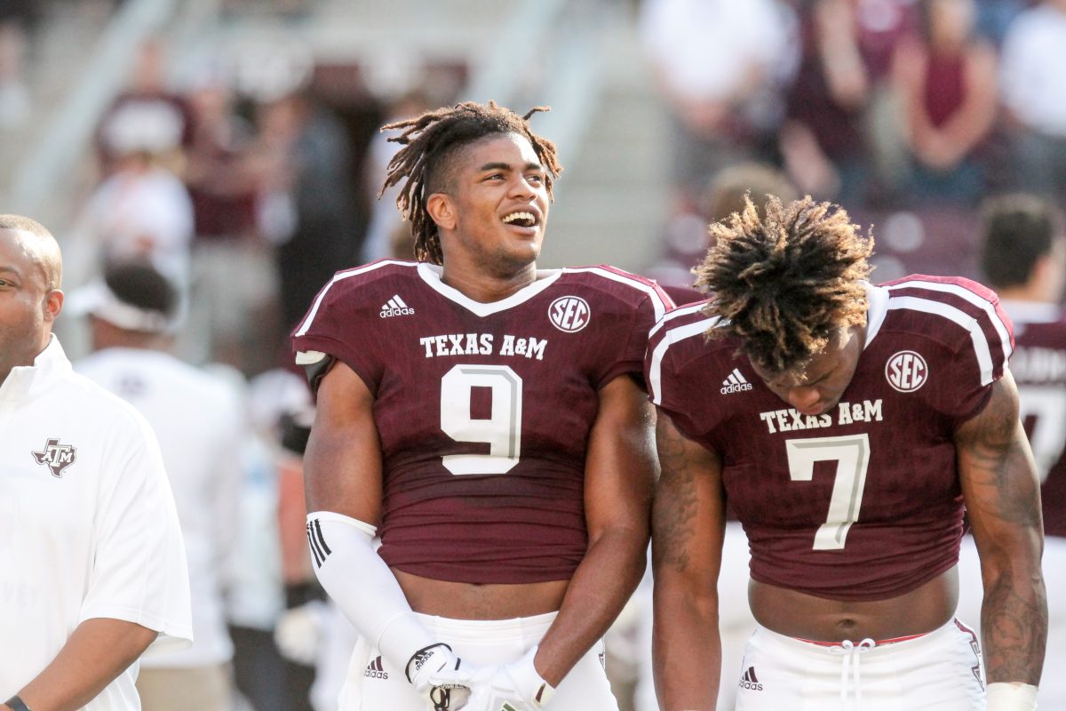 Senior&#160;Qualen Cunningham&#160;and freshman&#160;Buddy Johnson&#160;stand together before the singing of the Aggie War Hymn.