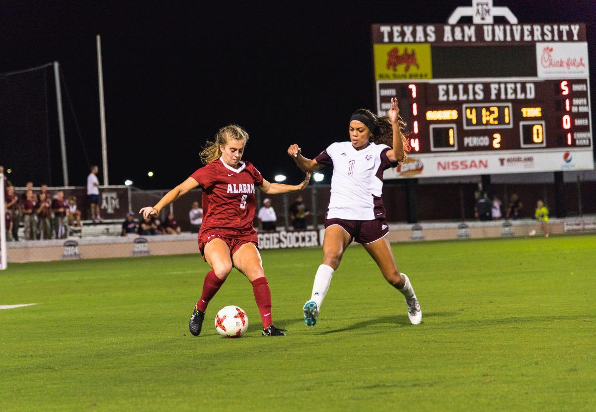 Ally Watt attempts to steal the ball from an Alabama player. 