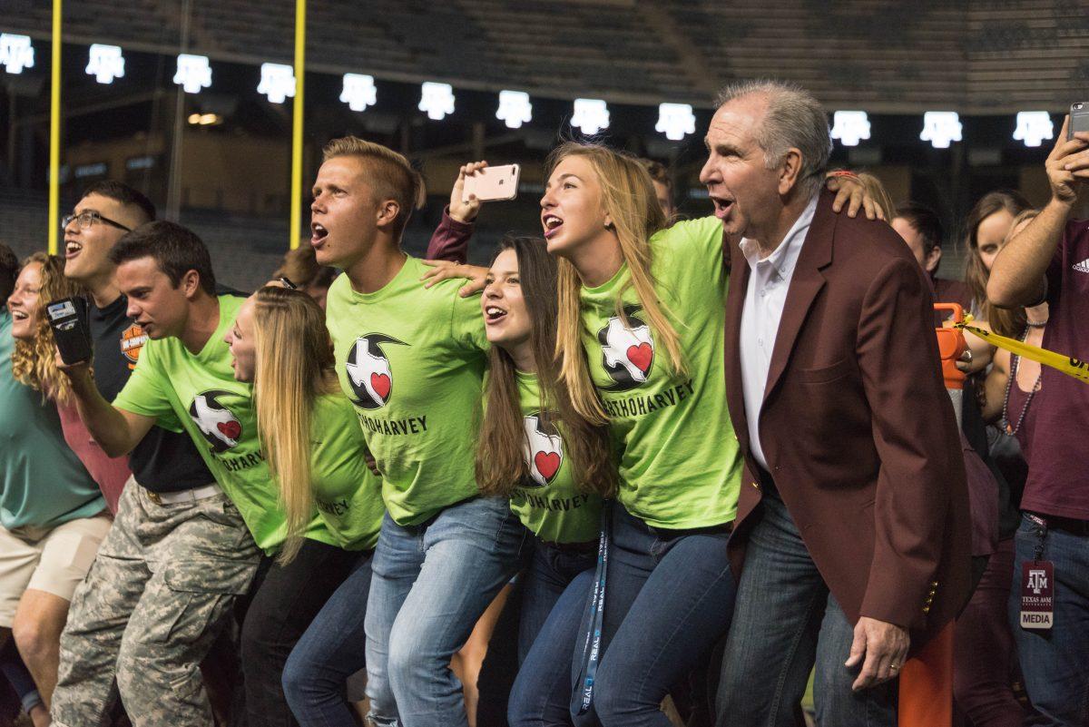 Texas A&M President Michael Young sings the War Hymn with students at the first Midnight Yell of the year. 