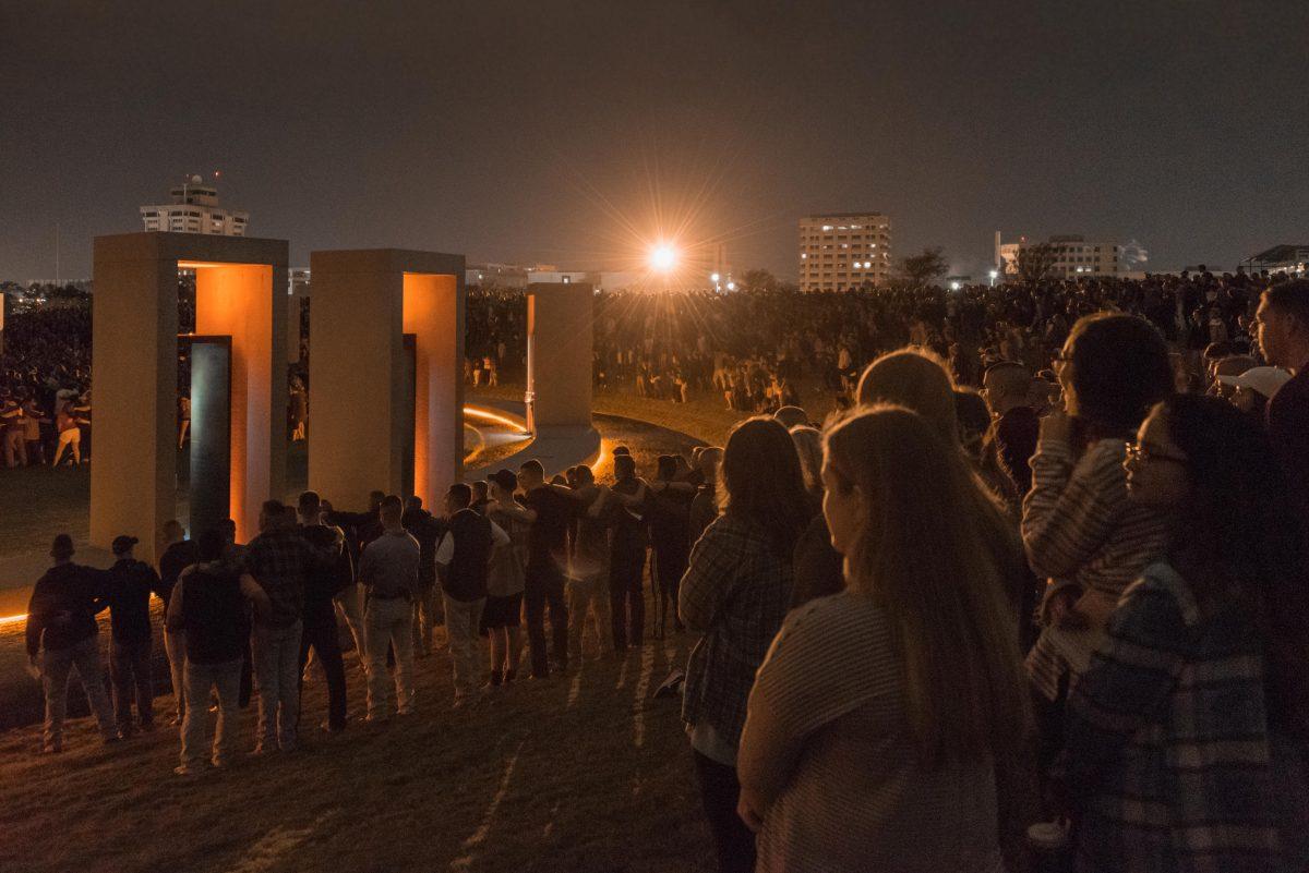 Students, former students, families and friends gather around the Bonfire Memorial during the early morning of Nov. 18, 2016.