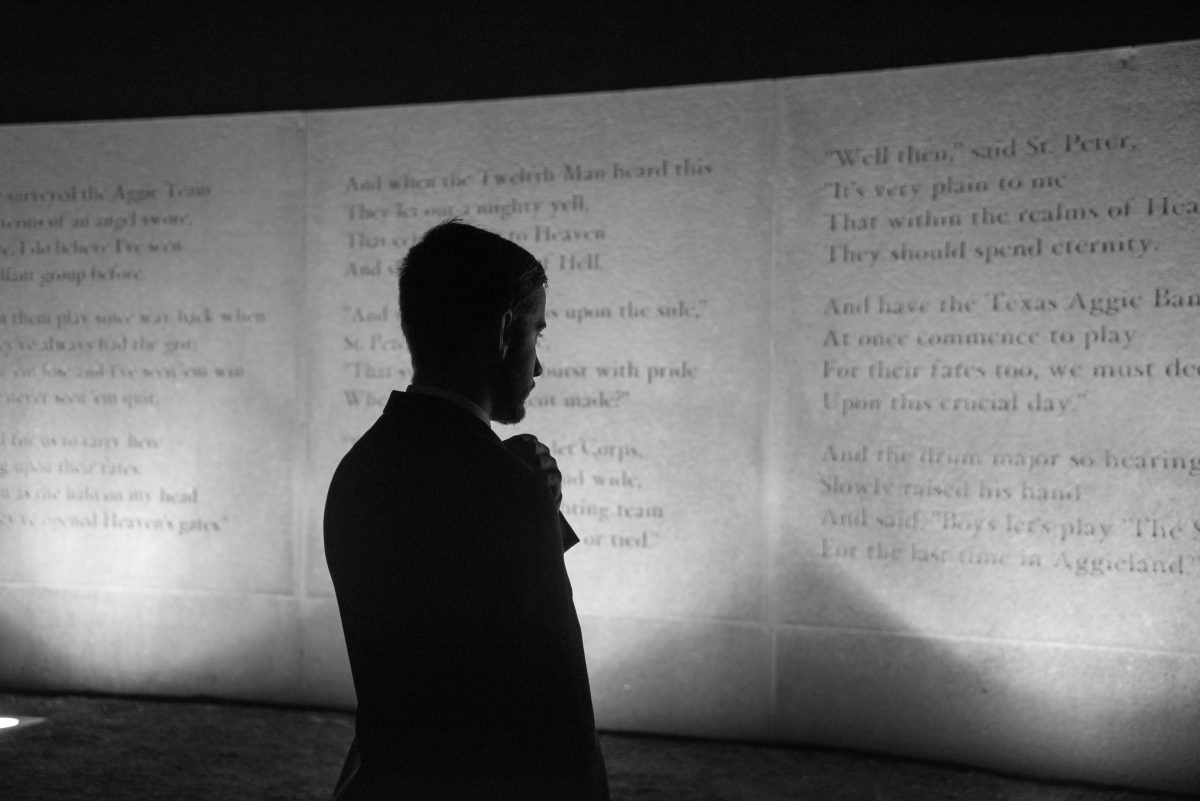 People stopped to read "The Last Corps Trip" poem, written by Philo H. DuVal, Jr., '51, on their way to the memorial.