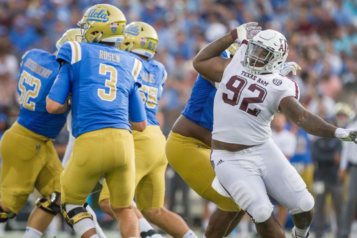 Senior defensive-lineman Zaycoven Henderson races around the offensive line to reach the quarterback. The Aggies would finish with 3 sacks. 