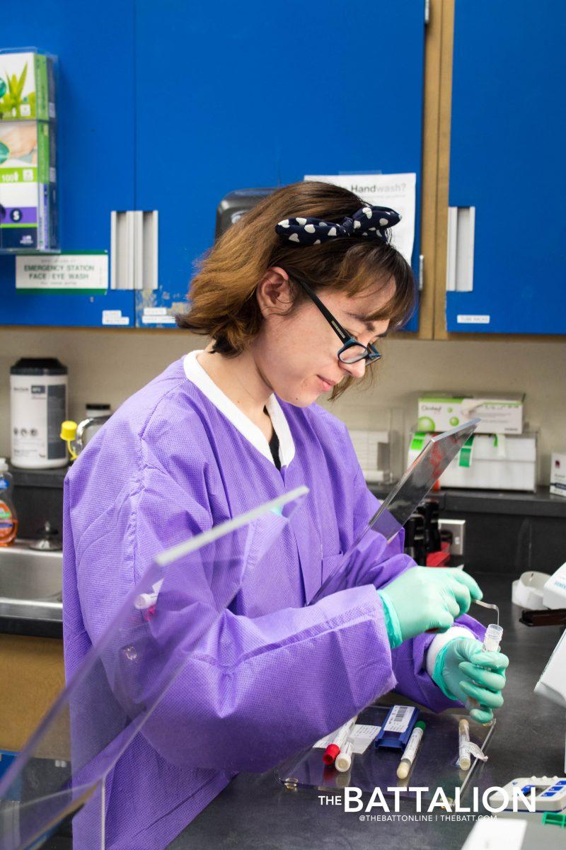 A lab technician runs tests for patients.