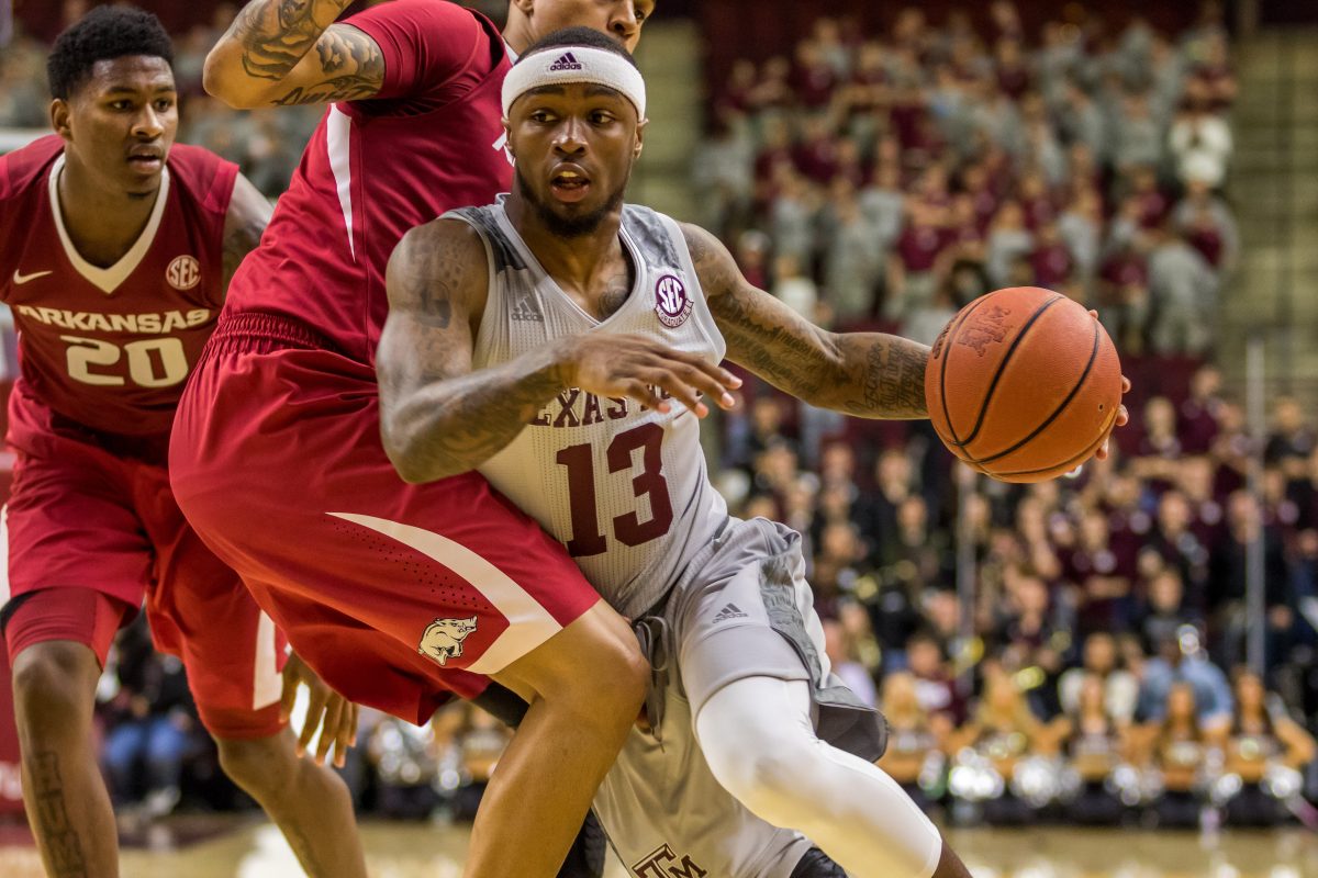 Graduate Guard&#160;Duane Wilson fights an Arkansas defender in an attempt to score.