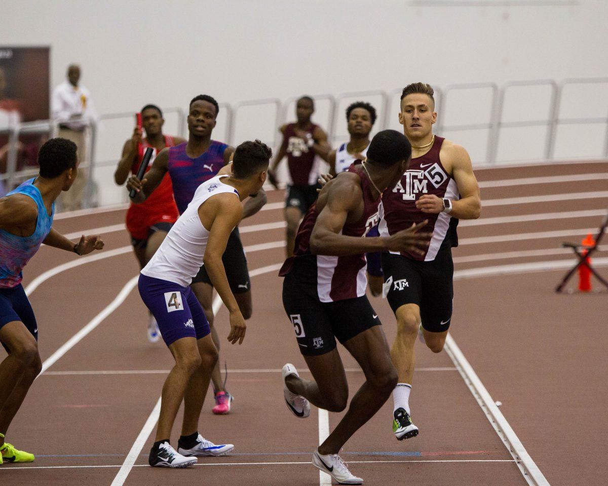 During the Mens 4x400 Relay seniors Robert Grant and Mylik Kerley look to each other for a smooth baton pass.