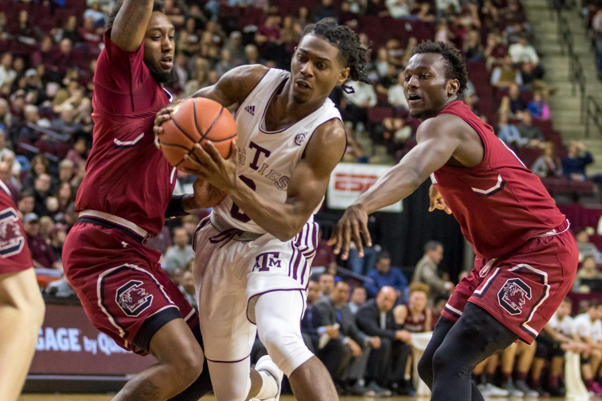 Freshman Point Guard Jay Jay Chandler squeezes past to South Carolina defenders.