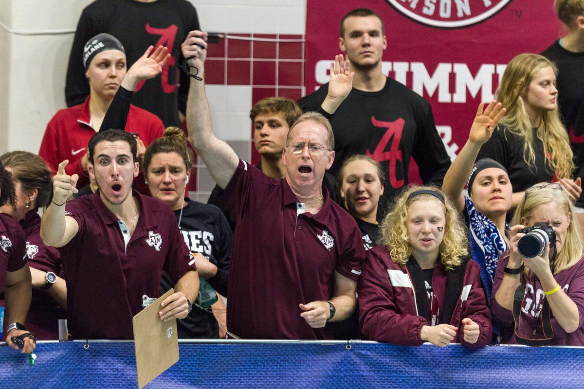Women's head coach Steve Bultman cheers on freshman Haley Yelle during the 1650-yard freestyle final, which was the first event of the final night of competition.