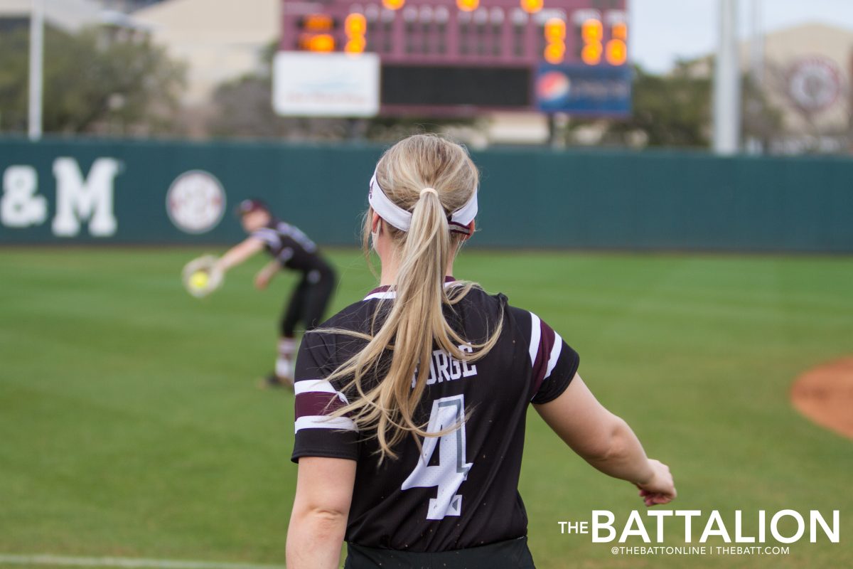 Freshman Kylie George warms up with a partner before the game.