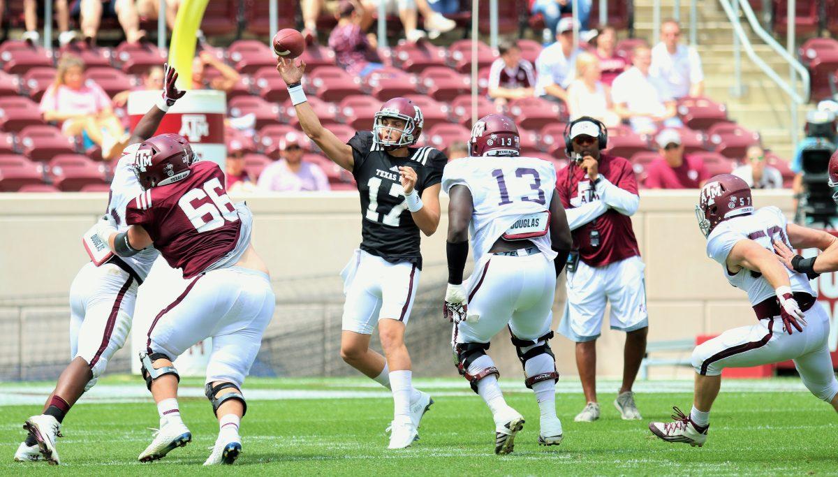 Nick+Starkel+throws+a+pass+with+head+coach+Kevin+Sumlin+right+behind+him.