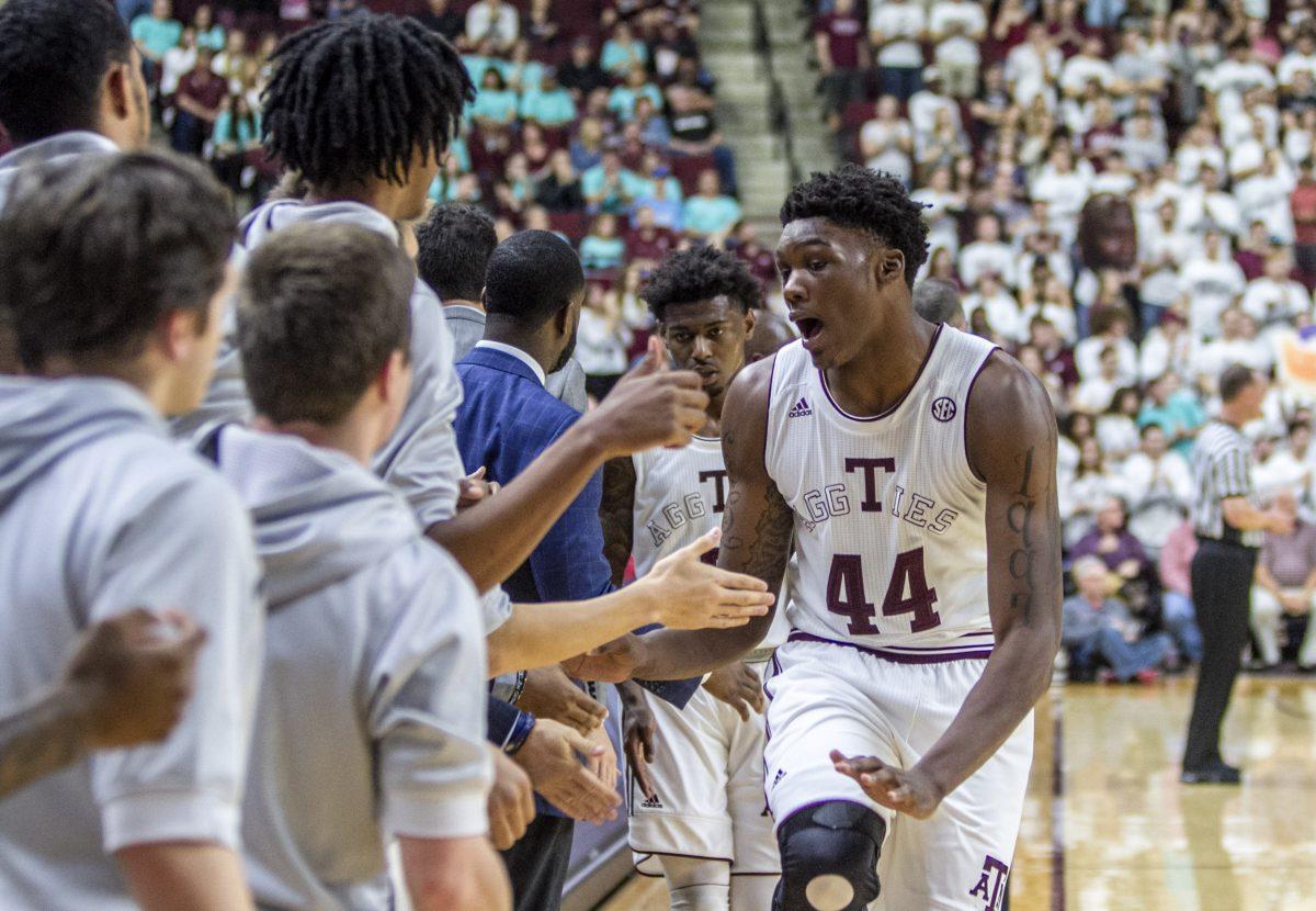 The bench players welcome back sophomore Robert Williams&#160;after being subbed.