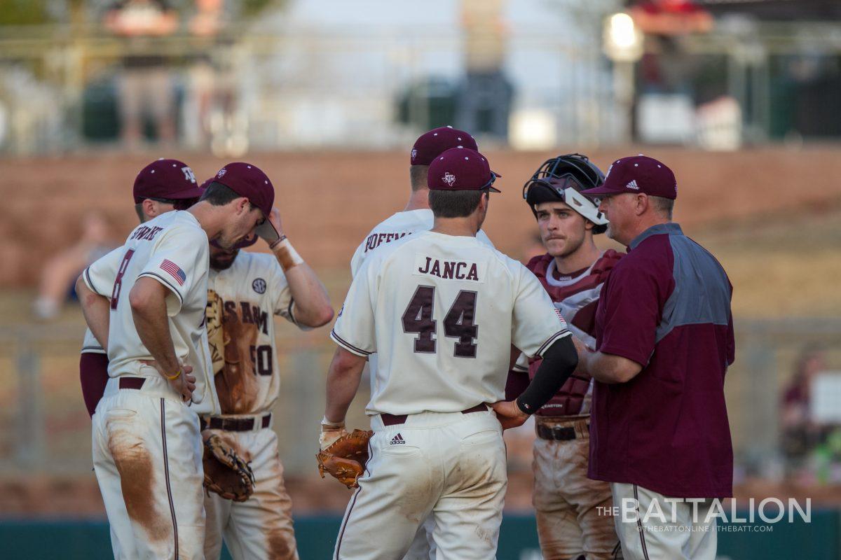 Head baseball coach Rob Childress meets with the infielders on the mound.