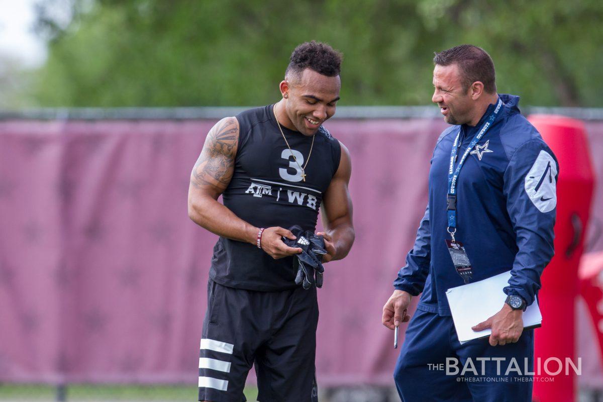 Christian Kirk talks to a Dallas Cowboys scout.
