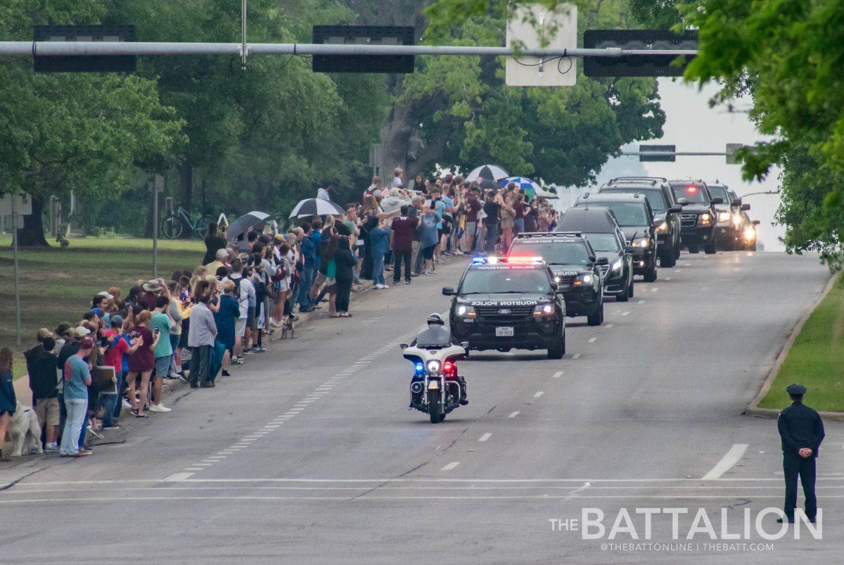 The motorcade peaks over a hill found along George Bush Drive.