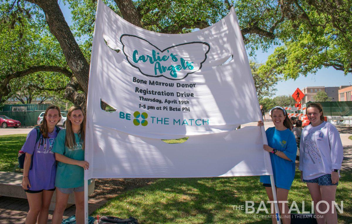 Sophomore&#160;Page Coleman, freshmen Miranda Dickson&#160;and&#160;Maddie MacArthur and sophomore&#160;Lizzie Priest hold the Charlie's Angel banner outside of the MSC.