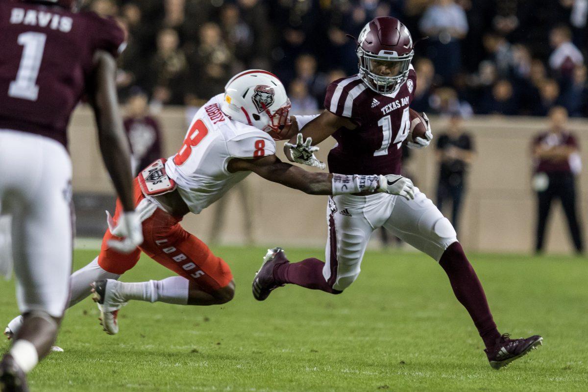 Freshman Wide Receiver&#160;Camron Buckley stiff arms a New Mexico defender after catching a pass.