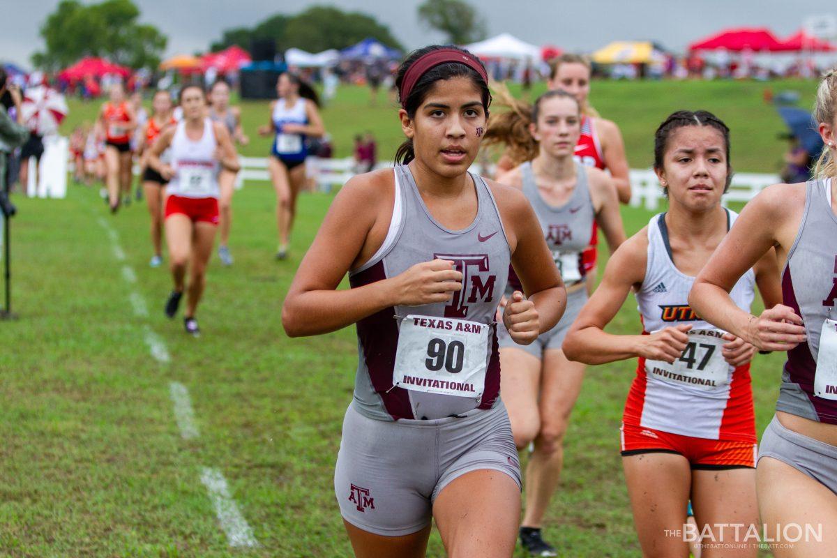 Junior&#160;Lauryn Barrientos rounds the first lap marker of Watts Cross Country Course.