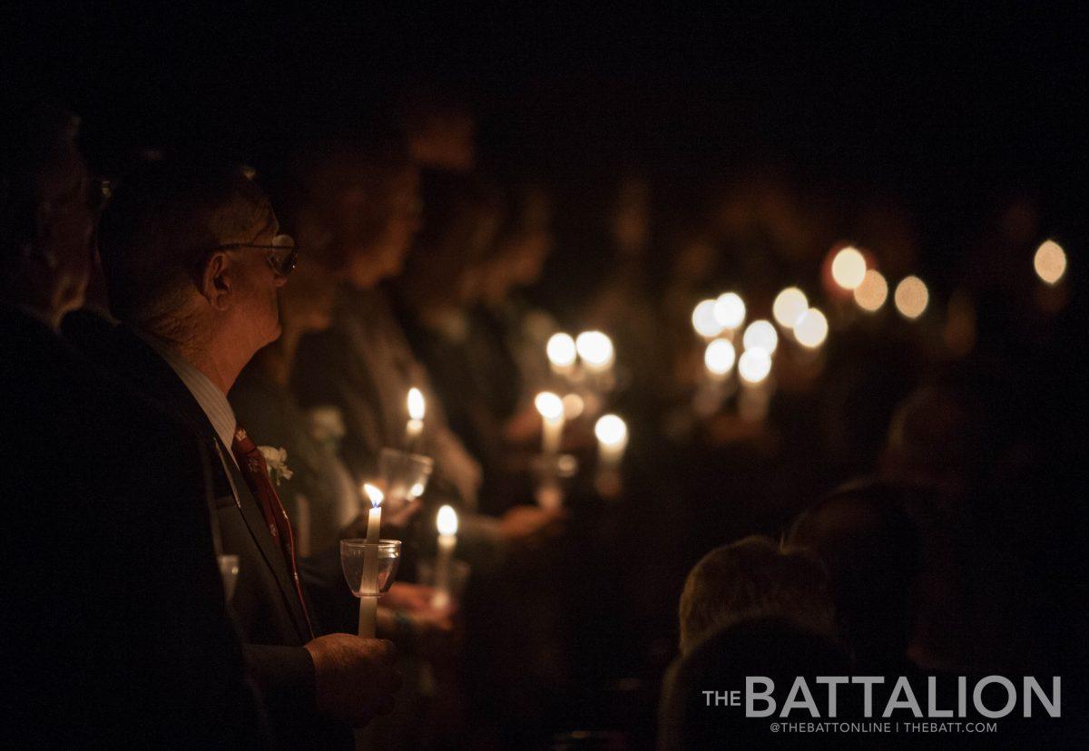 Candle holders surround Reed Arena as the audience pays their respects to the names called.