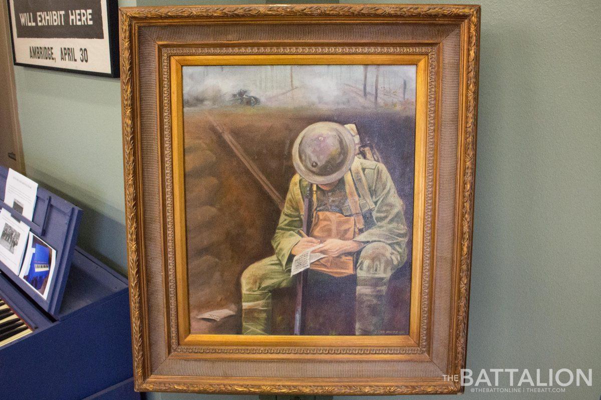 A painting by local artist Julie Metz shows J.V. Pinky Wilson writing the Aggie War Hymn. 