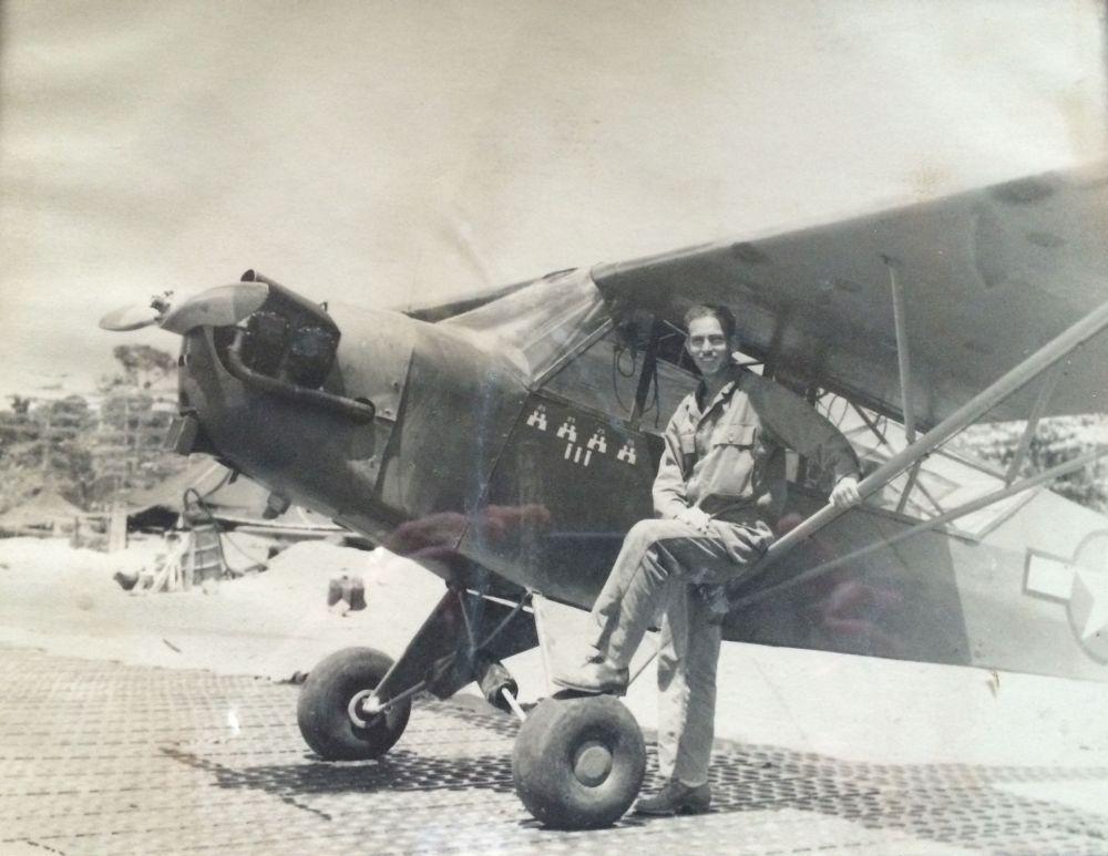 Bill Jones poses with his Piper Cub spotter airplane during World War II.