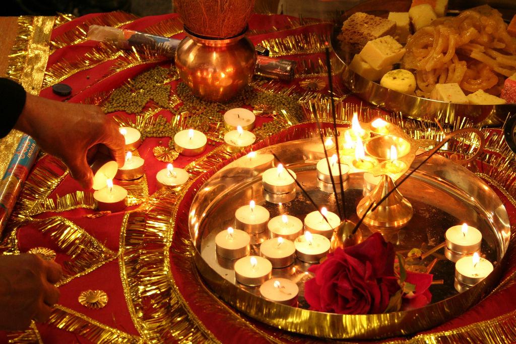 The community lights lamps and candles to celebrate Diwali.