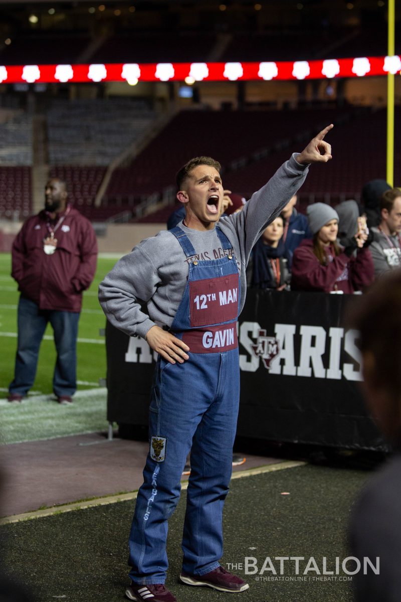 Head Yell Leader Gavin Suel prepares the crowd for the game with a spirited yell.