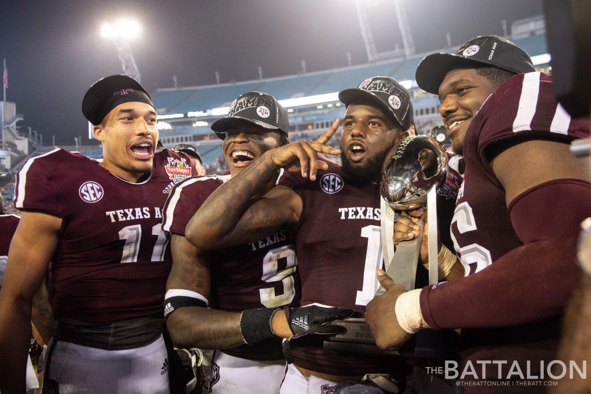 The Aggie players had a chance to hold and pose with the&#160;Taxslayer Gator Bowl trophy.