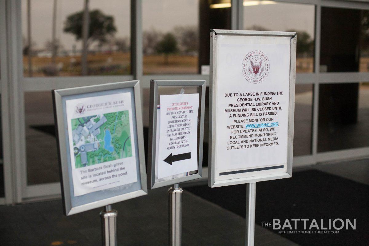 Signs in front of the George Bush Presidential Library and Museum direct visitors to the Bush family gravesite behind the pond and explain why most of the museum is currently closed.
