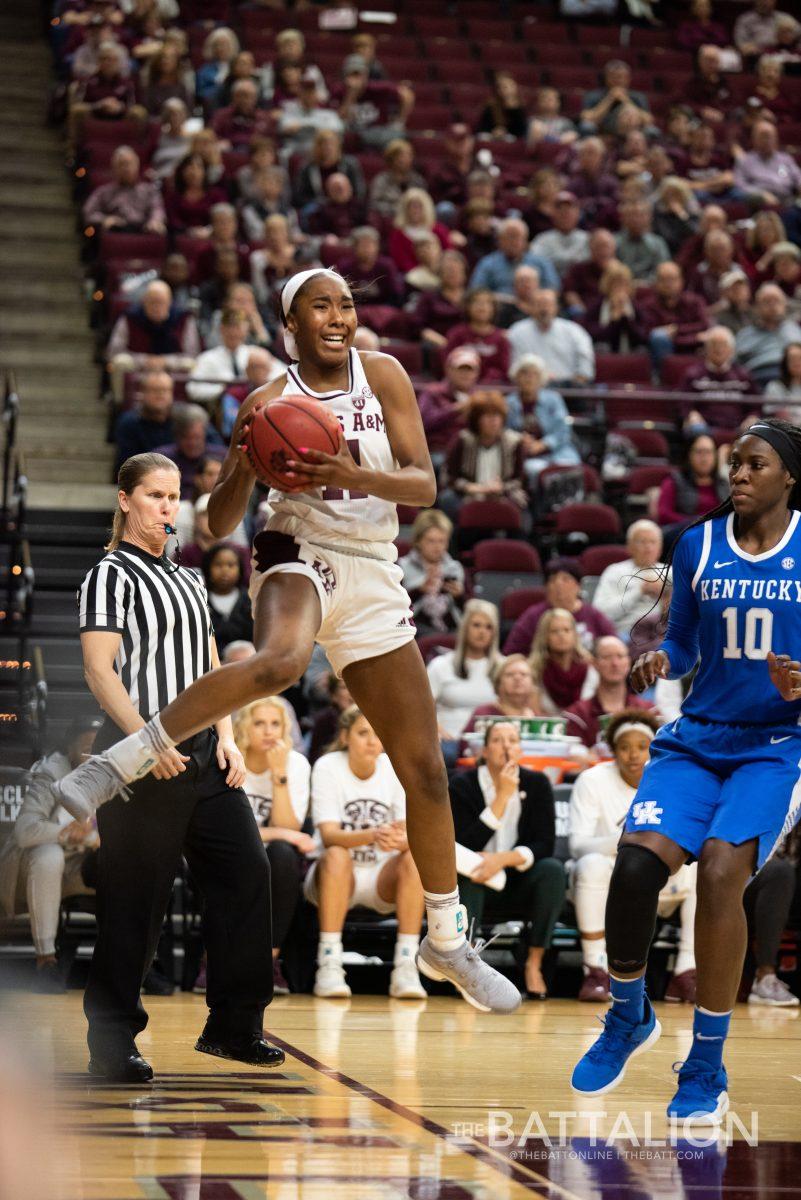 Sophomore guard Kayla Wells tries to keep the ball from going out of bounds.