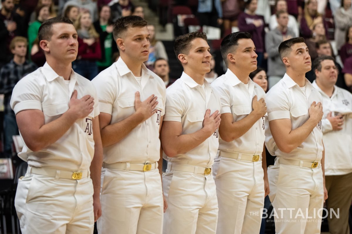 Yell Leaders Reid Williams, Blake Jones, Gavin Suel, Connor Joseph and Karsten Lowe stand with their hands over their hearts during the National Anthem before the men's basketball game against Missouri on Jan. 19.