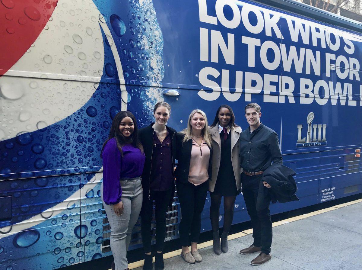 Environmental geoscience and economics senior Hayden Smith (right) poses in front of a Pepsi truck at the Super Bowl.