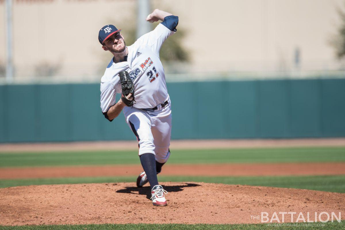 Freshman left hand pitcher Jonathan Childress practices before the next inning.