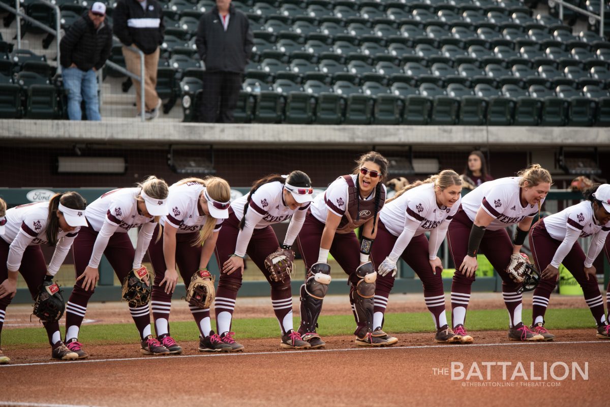 The Aggie softball team lines up for a pre-game ritual.