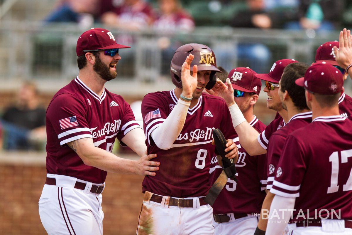 Aggies celebrate after junior Braden Shewmake scores in the bottom of the seventh inning off of a Ty Coleman single.
