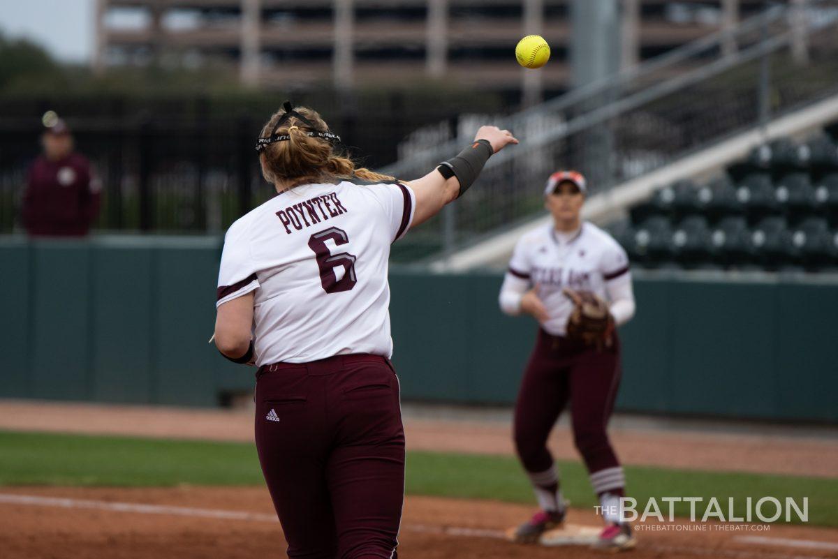Kayla Poynter throws the ball to Baylee Klingler to get a runner out on first.