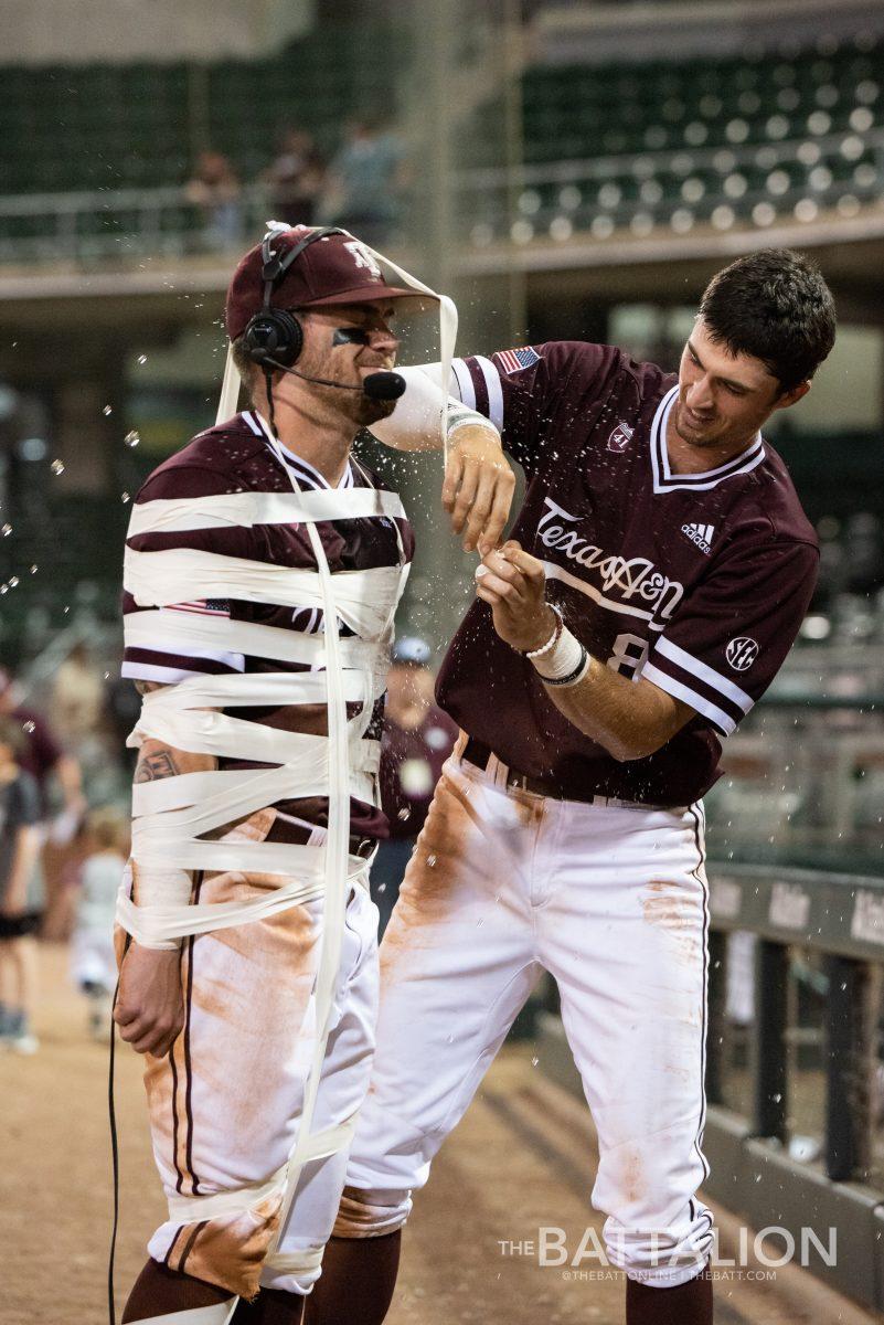 Braden Shewmake wraps Logan Foster in&#160;athletic tape during Foster's post-game interview after Texas A&amp;M defeated Missouri 7-3 on March 30 at Olsen Field.