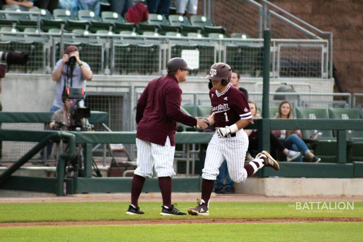 Ty Coleman&#160;celebrates with Coach Childress as he rounds third and heads home after his home run.