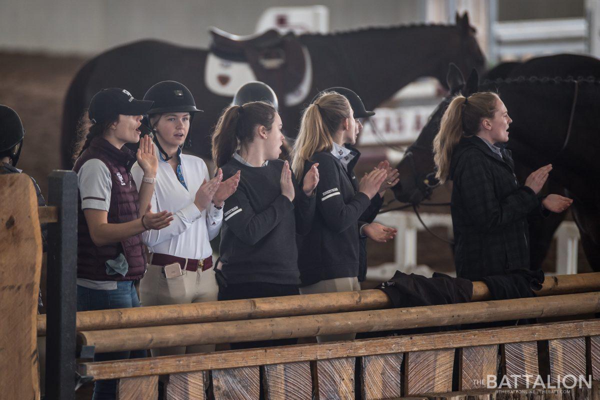 Members of the Texas A&M Equestrian Team cheer for their teammates competing during Equitation on the Flat. 