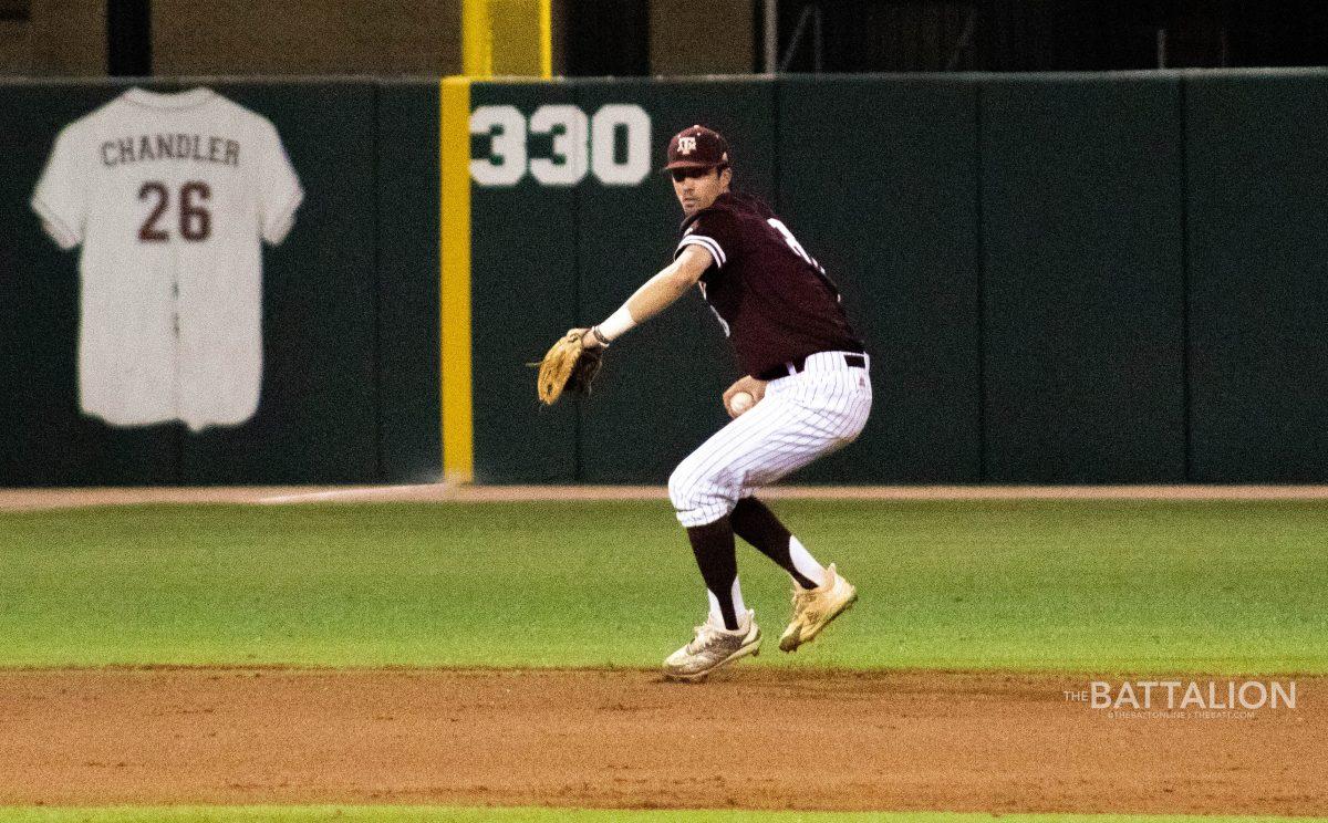 Junior&#160;Braden Shewmake fields a ground ball at shortstop and throws the runner out at first.