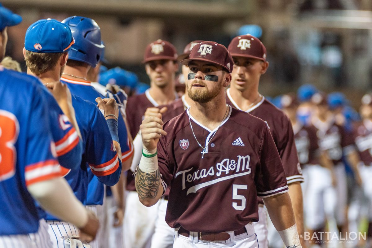 The two teams line up and fist-bump each other after the game.