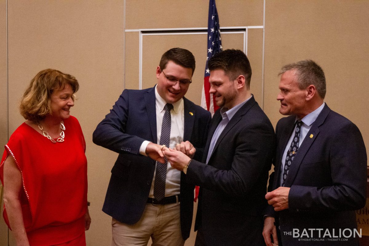 Mechatronics senior Jonas Lossner shows off his new Aggie ring to his brother Sebastian, Class of 2016, and his parents.