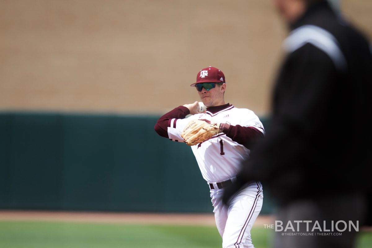 Freshman second baseman Ty Coleman&#160;throws out a runner at first base after fielding a ground ball.&#160;