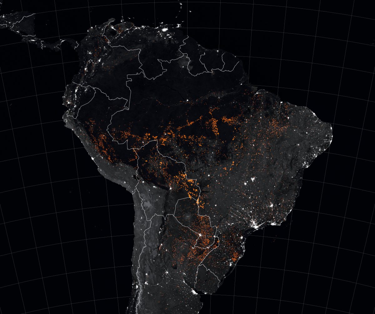 NASA uses the Moderate Resolution Imaging Spectroradiometer (MODIS) to detect fires via satellite. In images taken from August 15 to 22 fires can be seen in orange, cities and towns in white, forested areas in black and tropical savannas in gray.