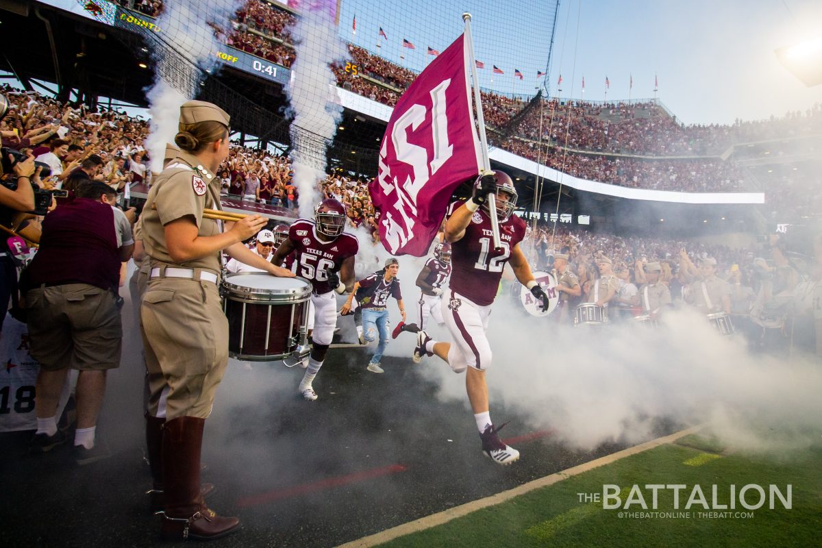 The Aggies’ 2019 12th Man, Braden White, leads the football team out of the tunnel for the first time before the Texas State football game.
