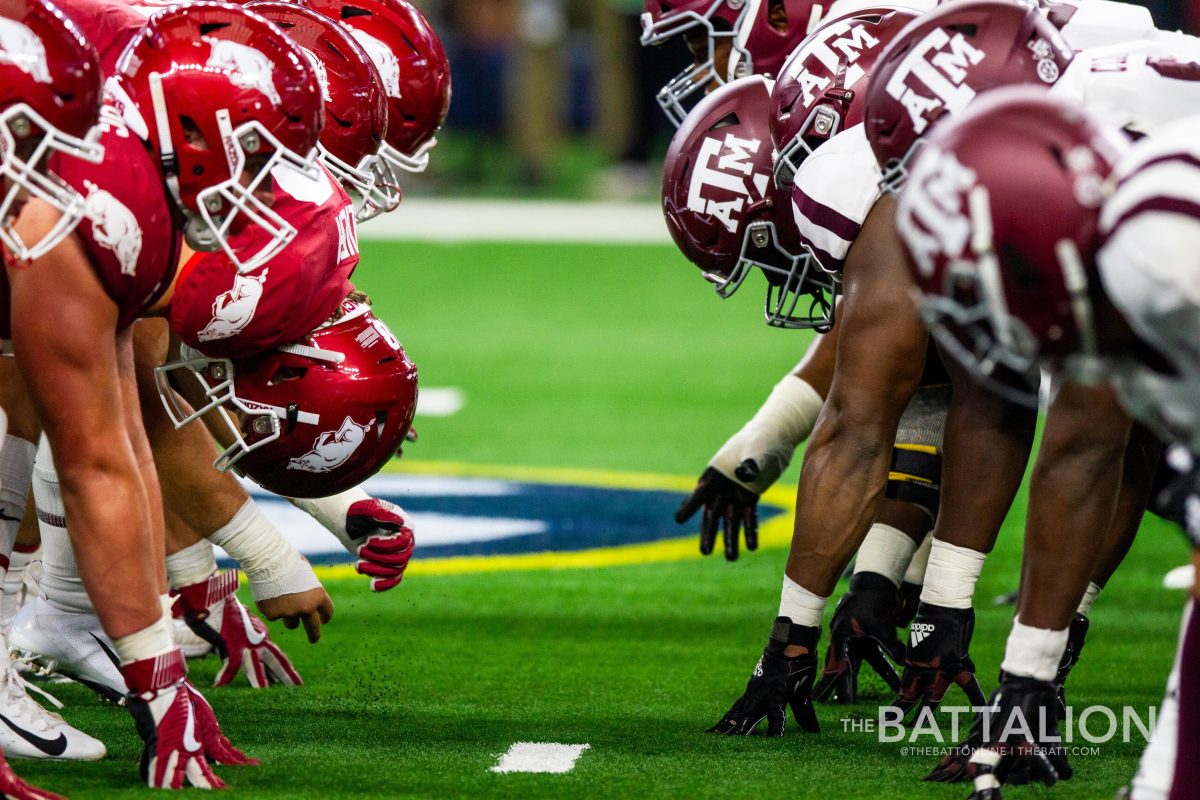 The Arkansas offense and Texas A&M defense leap  just after the snap.