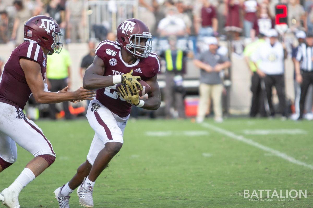 Junior&#160;Kellen Mond hands the ball off to Freshman&#160;Isaiah Spiller during the third quarter.