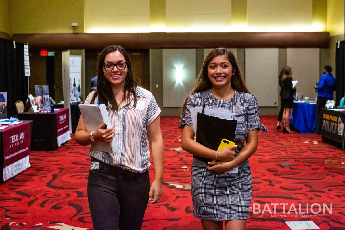 Junior communication majors Maddie Echols and Karla Coronado roam the aisles of potential employers at the Liberal Arts Career Fair. 
