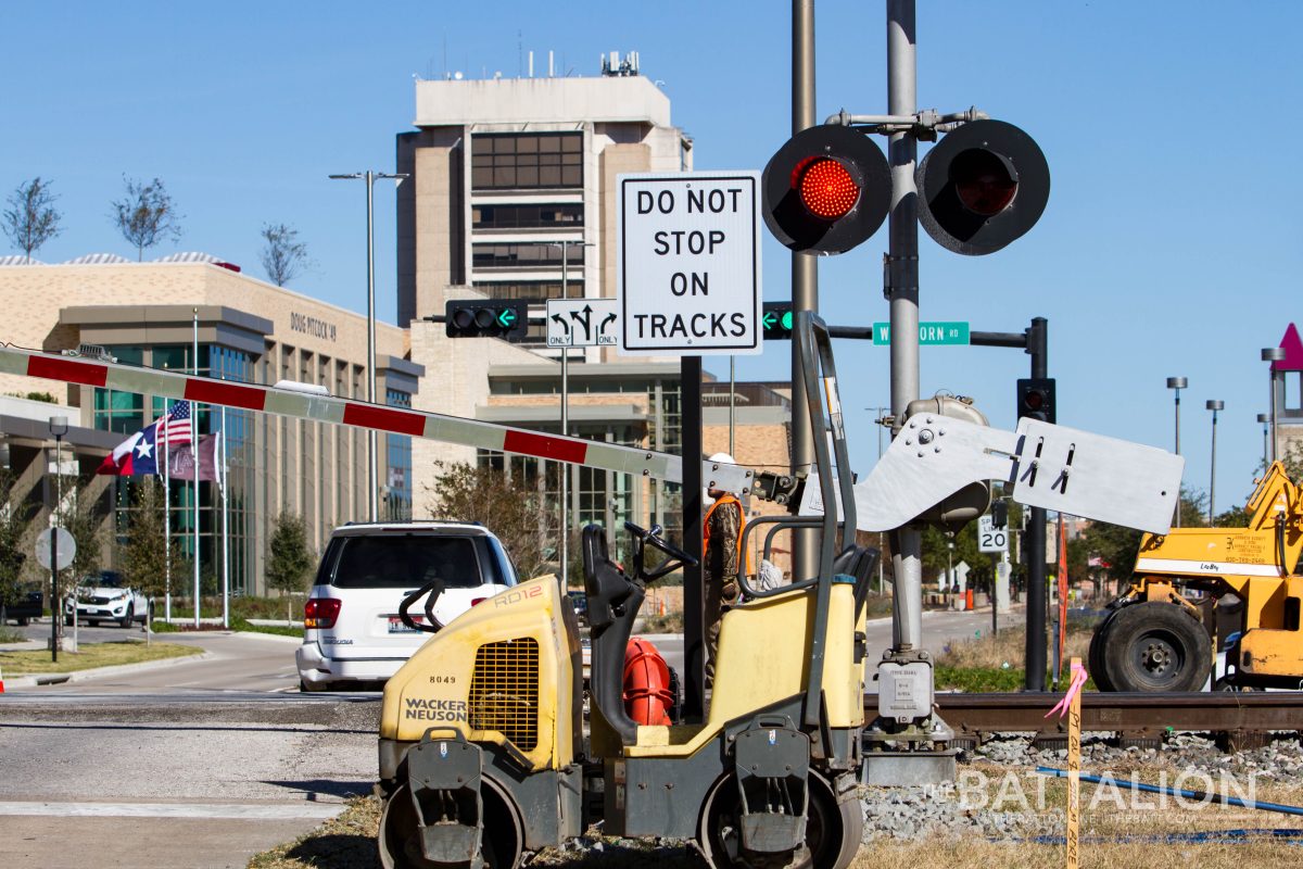 Construction workers maintain the railroad tracks at the intersection of Wellborn Road and John Kimbrough Blvd.